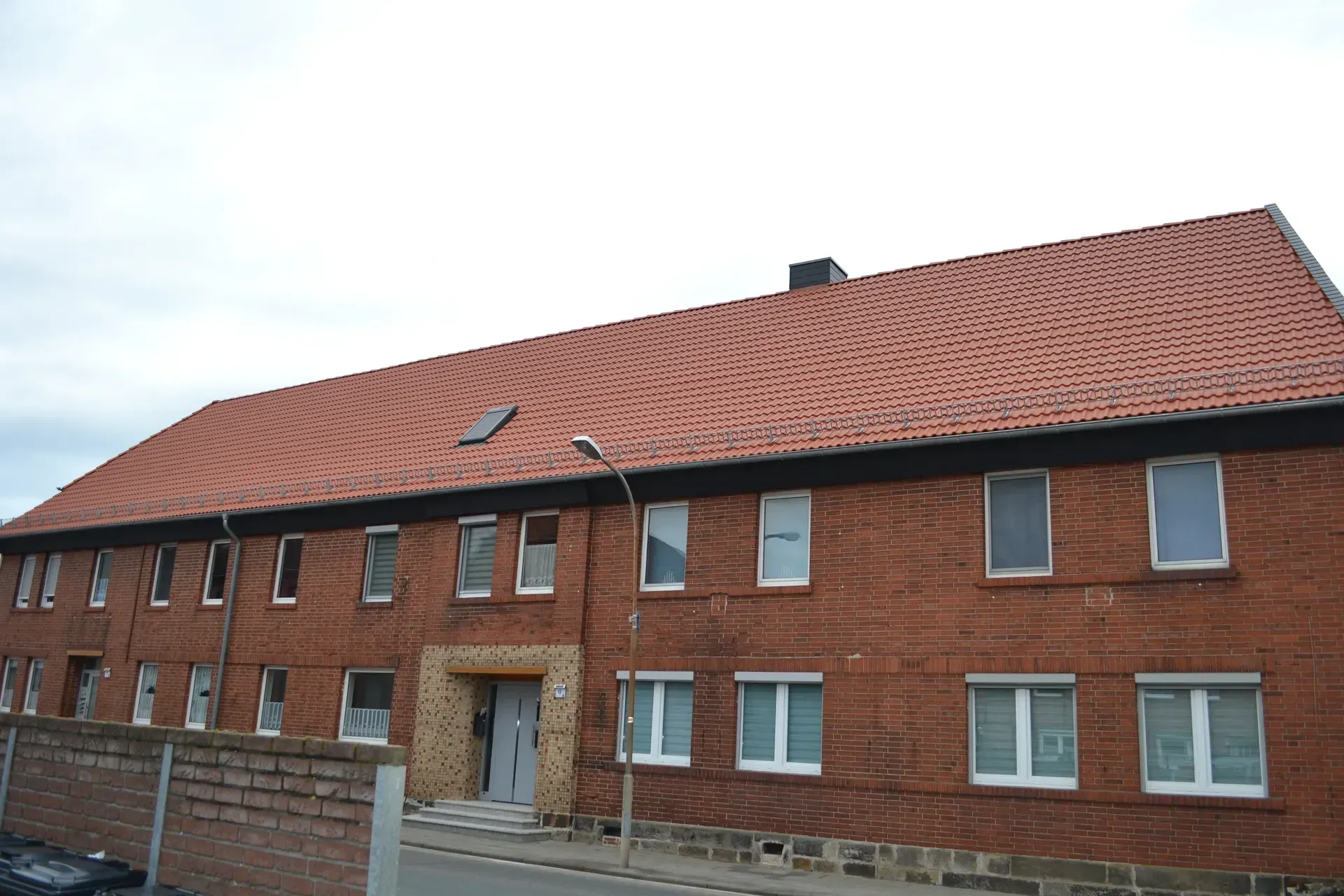 Großflächige Dachsanierung an einem Backstein-Mehrfamilienhaus